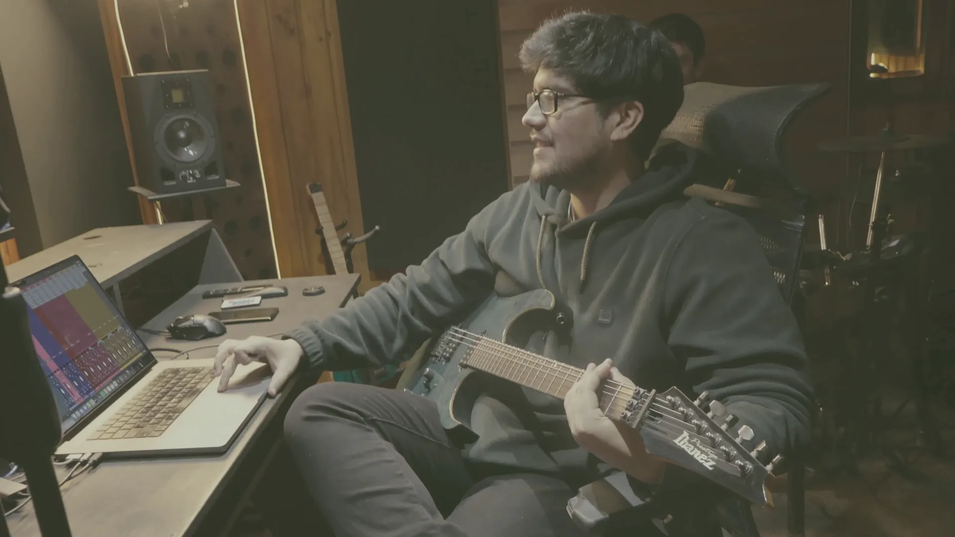 Felipe playing guitar in the studio